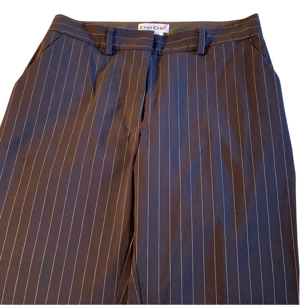 BEBE. Black pinstripe pants with pockets. 1 in back.Size 4. Split on bottom hem